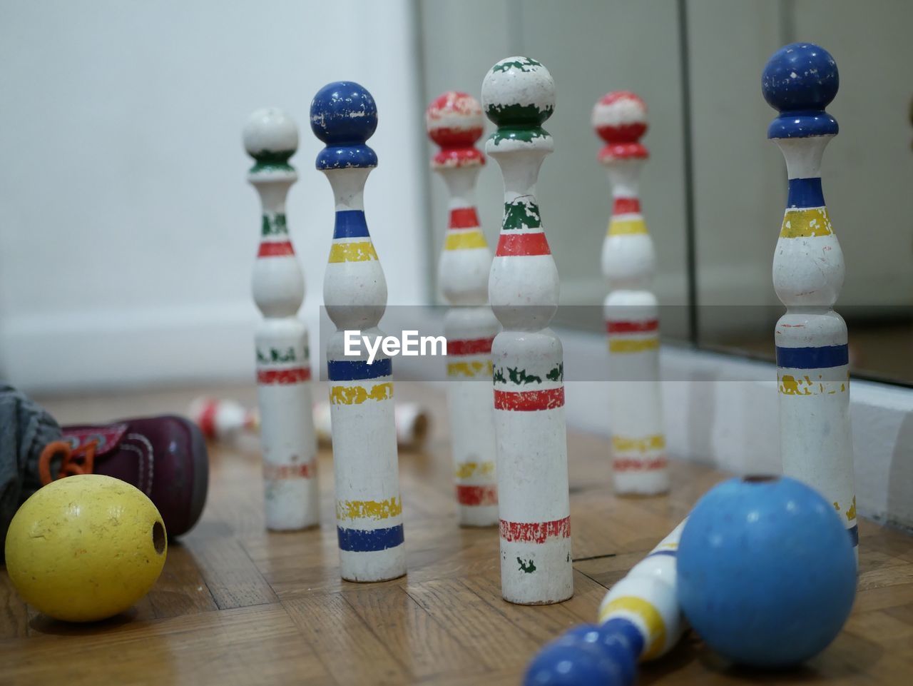 Close-up of bowling pins by balls on floor