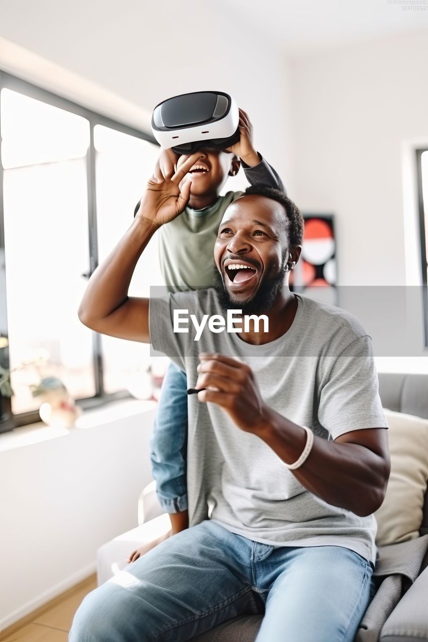 African family father and son playing a game using vr headsets.ai generated