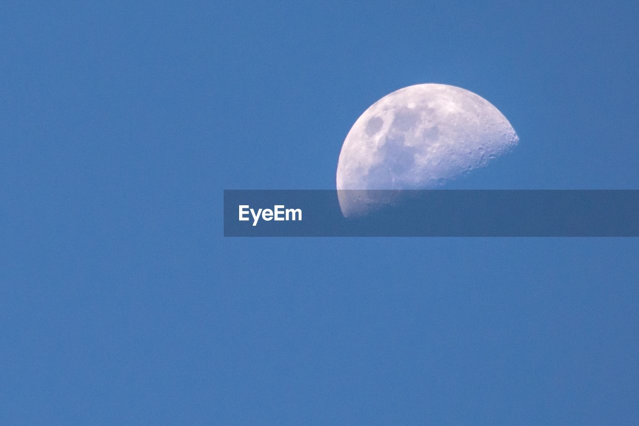 LOW ANGLE VIEW OF MOON IN SKY