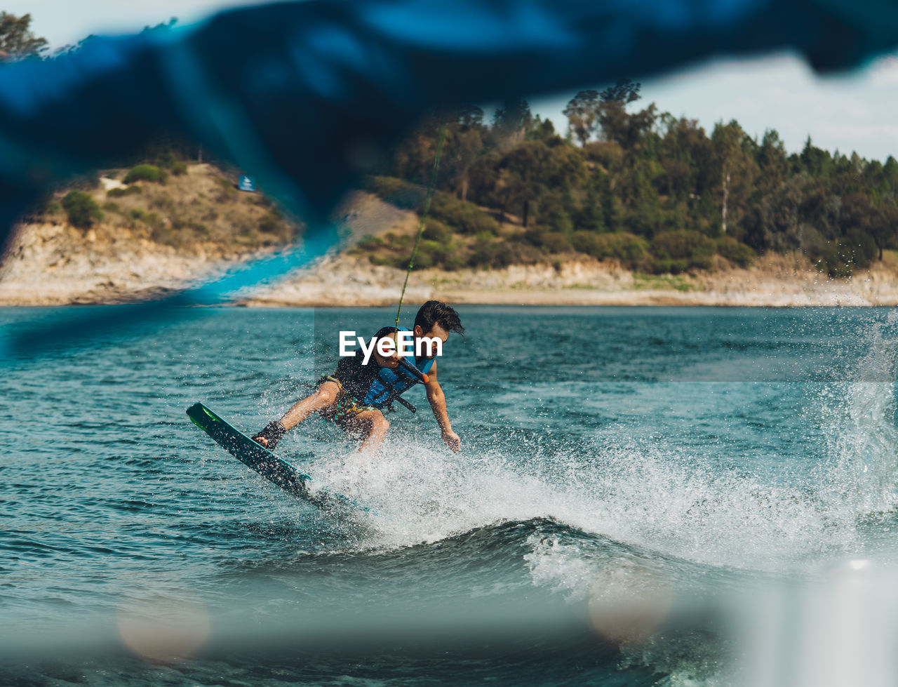 Full length of man doing wakeboard in a lake