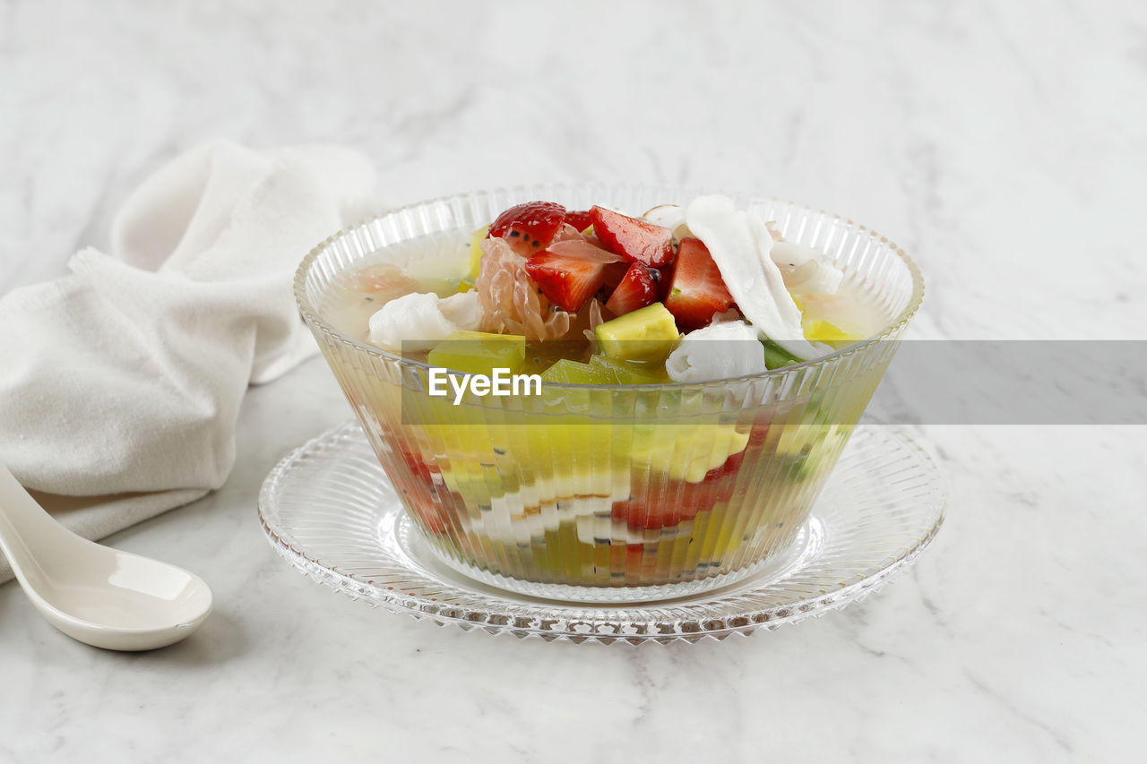 Fruit cocktail with strawberry, avocado, coconut meat, and pomelo with fresh sweet simple syrup