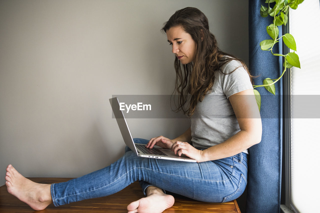 Individual woman on her laptop working / studying at home