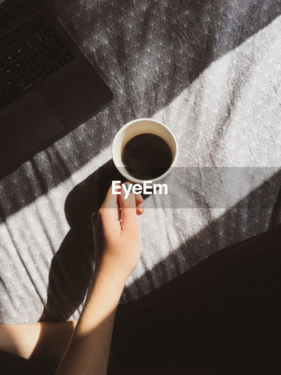 High angle view of woman holding coffee cup