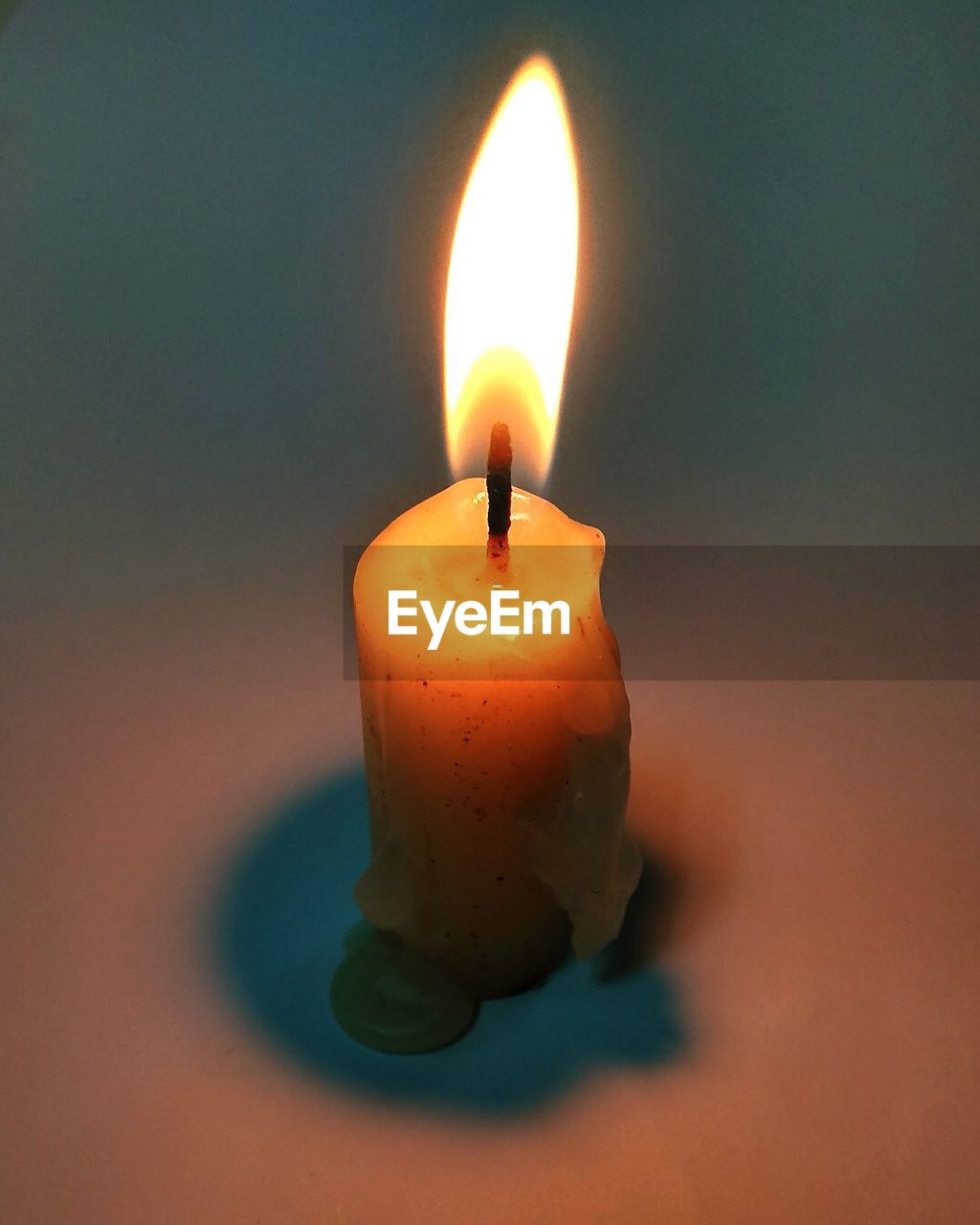 Close-up of candle burning on table
