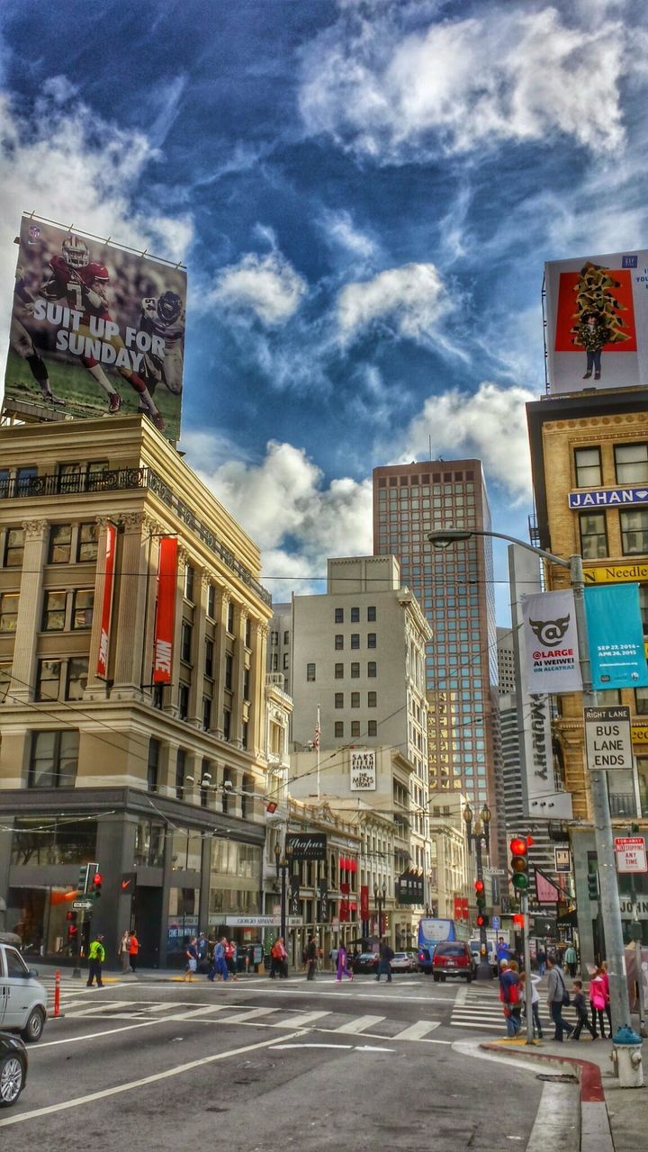 VIEW OF CITY BUILDINGS AGAINST CLOUDY SKY