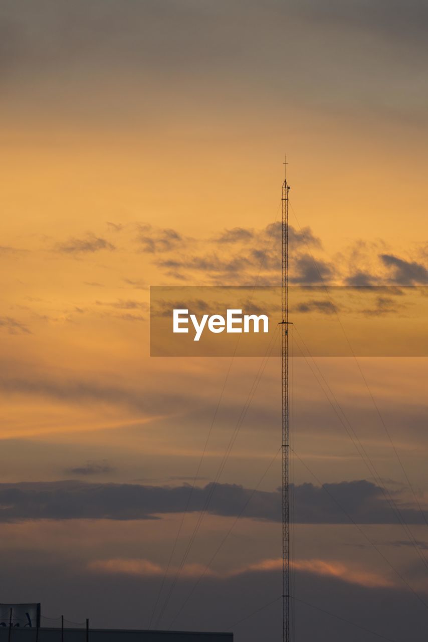 LOW ANGLE VIEW OF SILHOUETTE TOWER DURING SUNSET