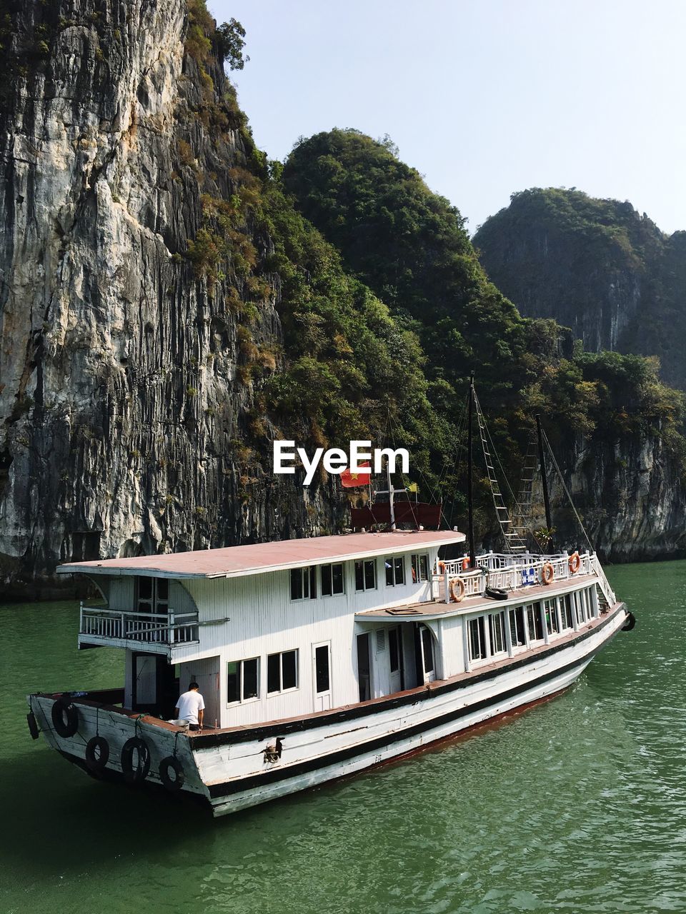 BOAT ON BRIDGE OVER RIVER AGAINST CLEAR SKY