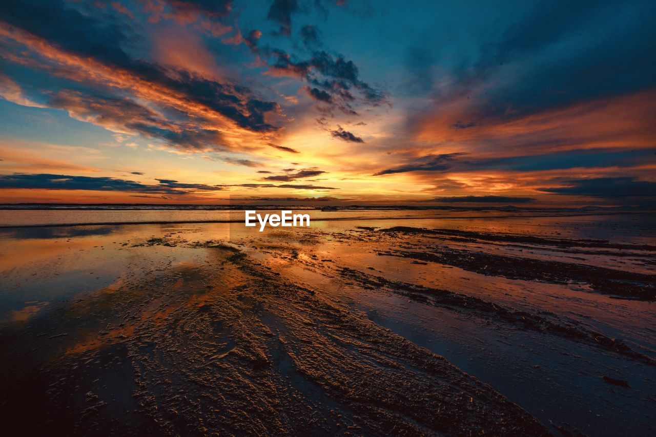 Scenic view of sea against romantic sky at sunset