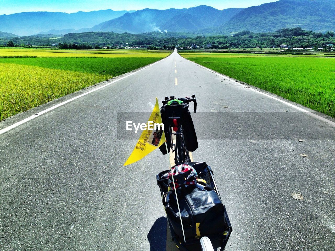 High angle view of bicycle on road amidst field against mountain