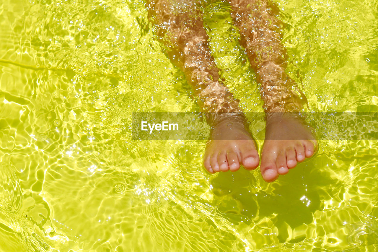 YOUNG WOMAN SWIMMING IN SEA