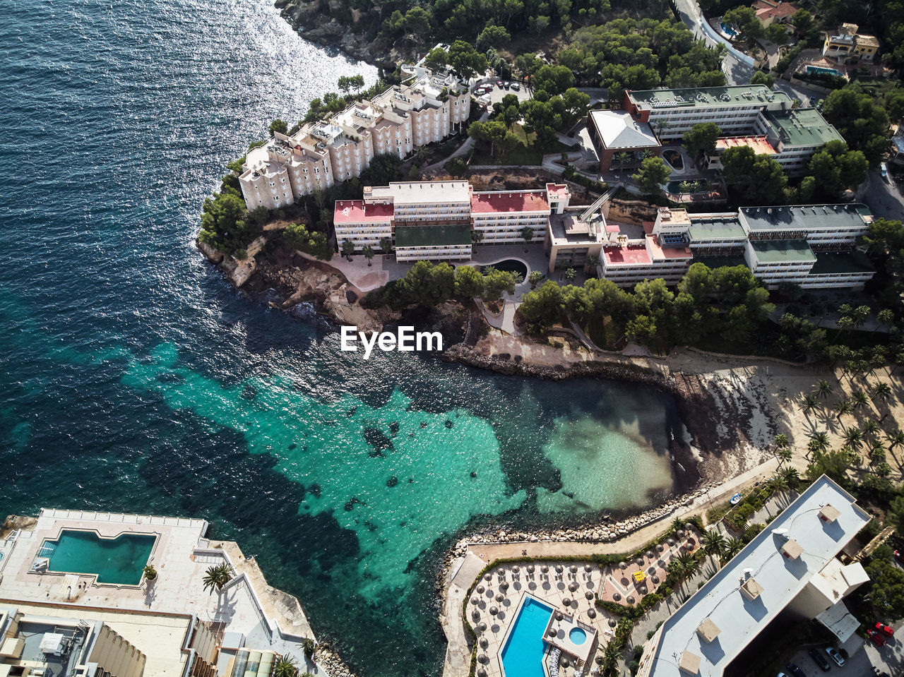 HIGH ANGLE VIEW OF SWIMMING POOL BY BUILDINGS