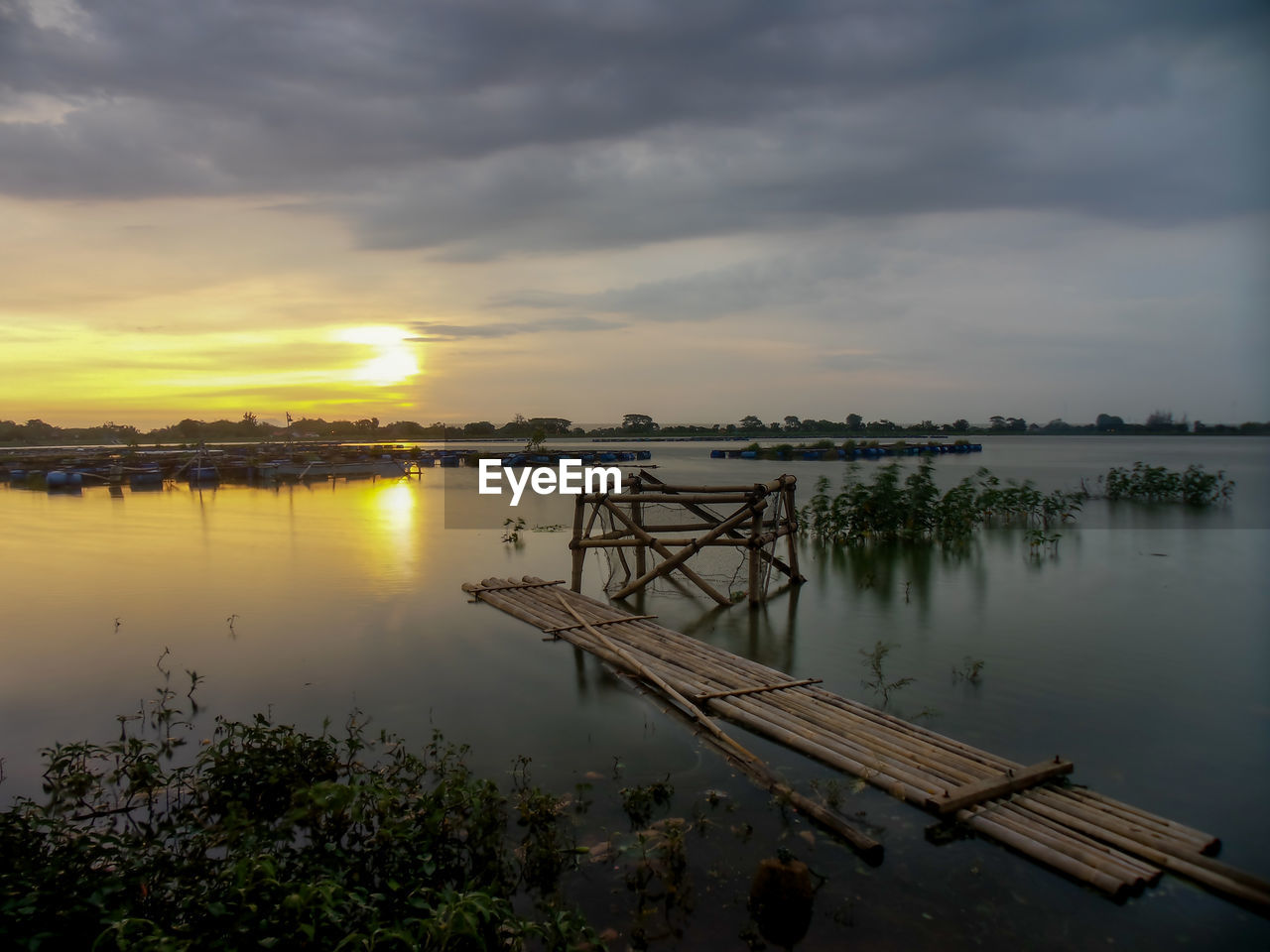 Scenic view of lake against sky during sunset