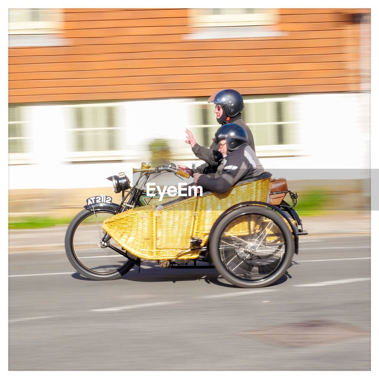 MAN RIDING MOTORCYCLE ON ROAD