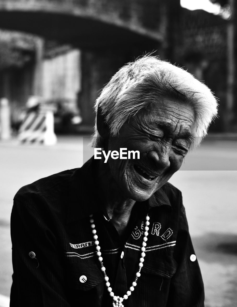 Cheerful senior woman in city
