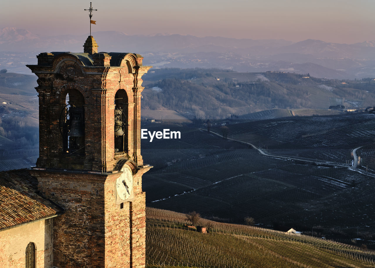 Historic building by mountains against sky