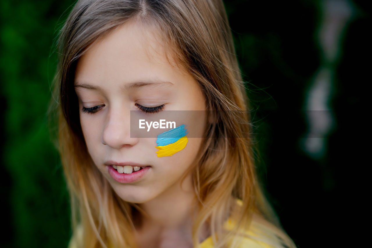 Close-up of young girl with ukrainian flag 