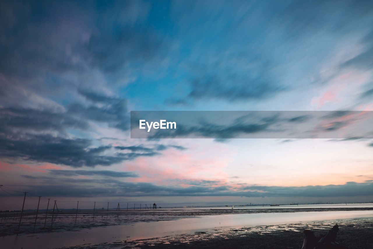 SCENIC VIEW OF DRAMATIC SKY OVER BEACH