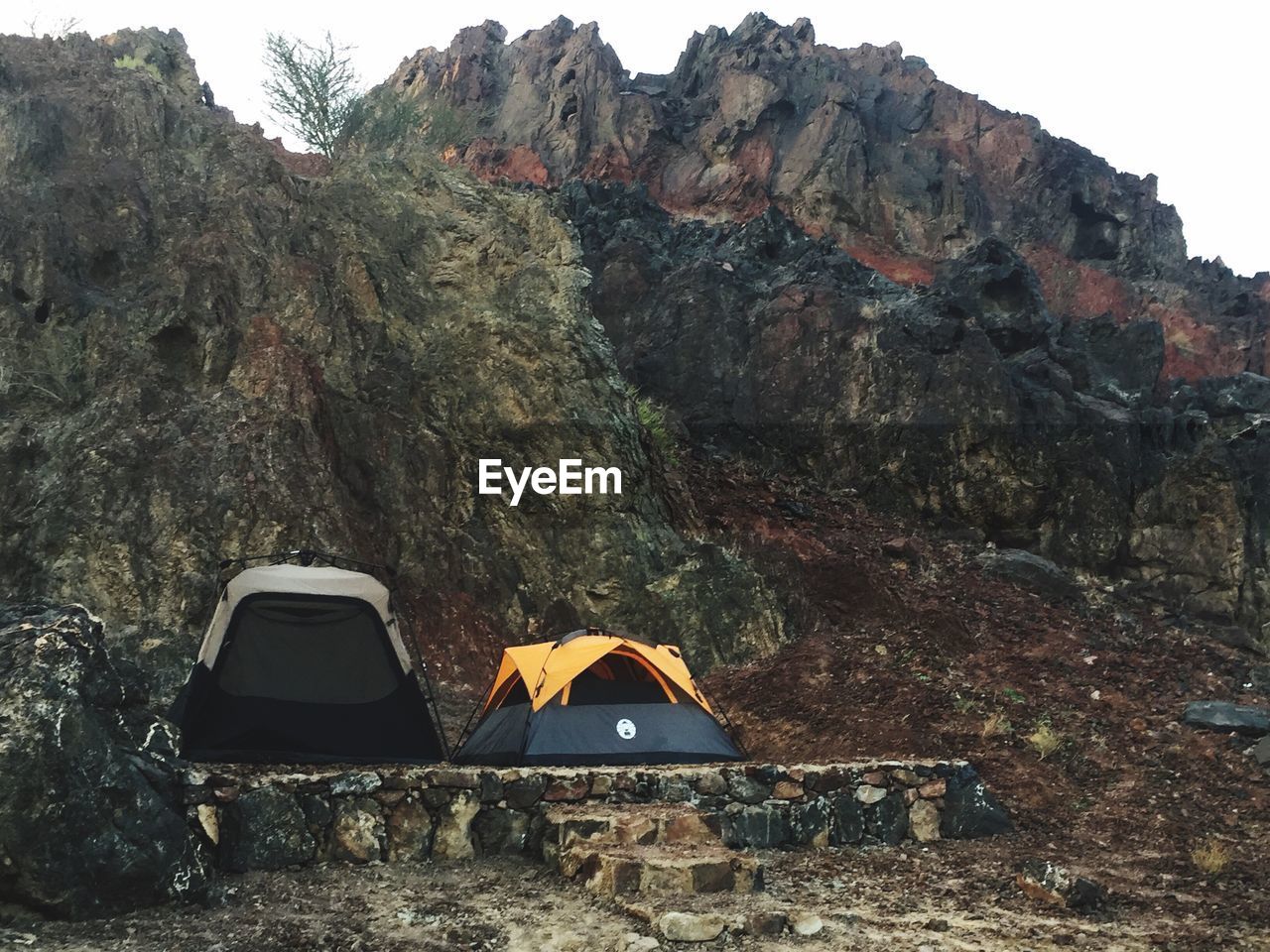 Tents on mountain against clear sky