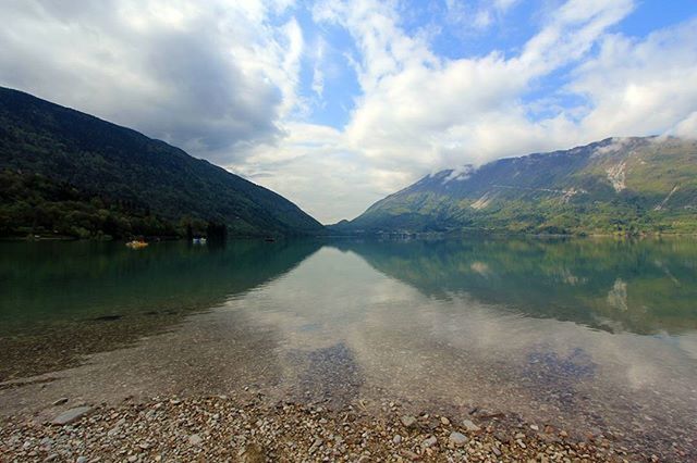 SCENIC VIEW OF LAKE WITH MOUNTAINS IN BACKGROUND