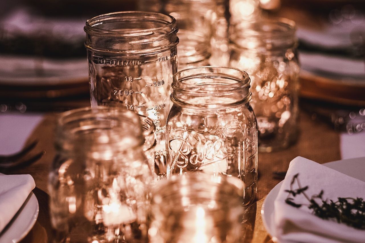 High angle view of illuminated glass jars on table