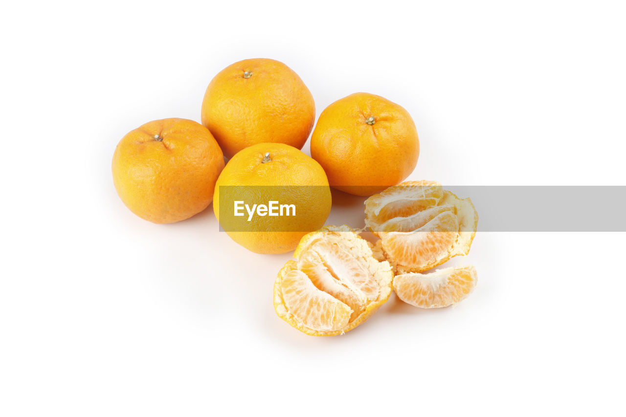 CLOSE-UP OF FRUITS AGAINST WHITE BACKGROUND OVER GRAY