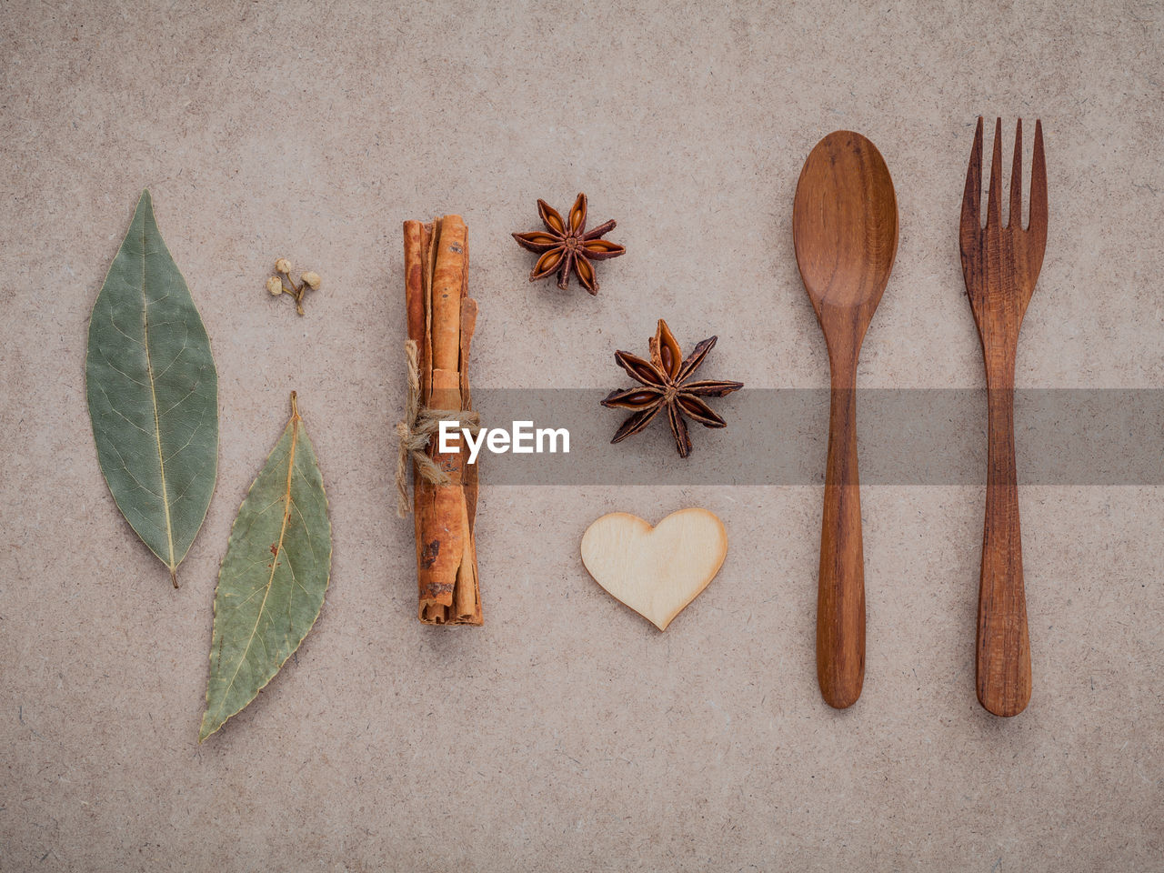 Directly above shot of star anise with cinnamon and wooden spoon