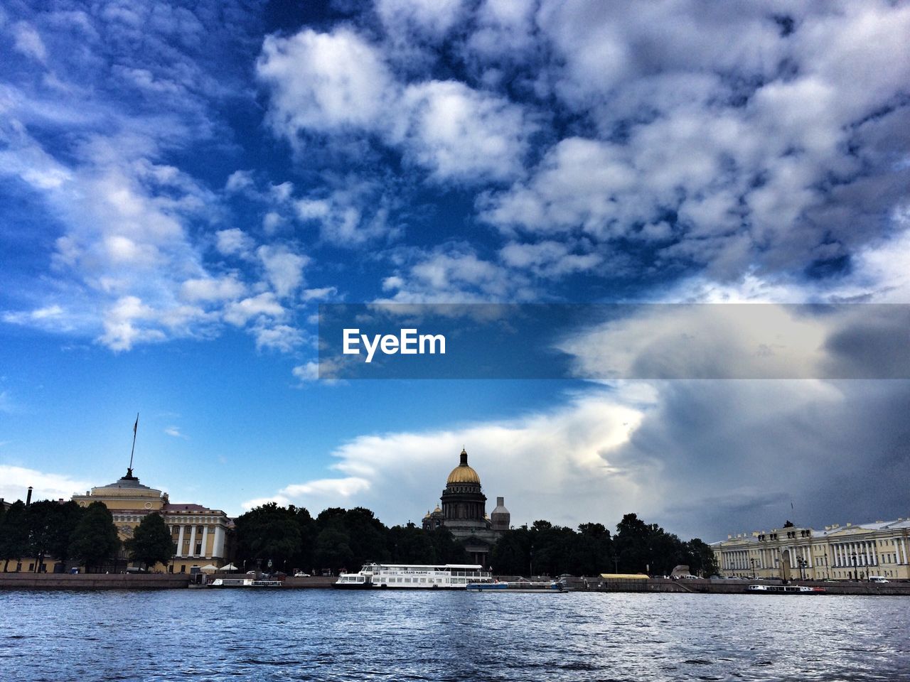 VIEW OF RIVER AGAINST CLOUDY SKY