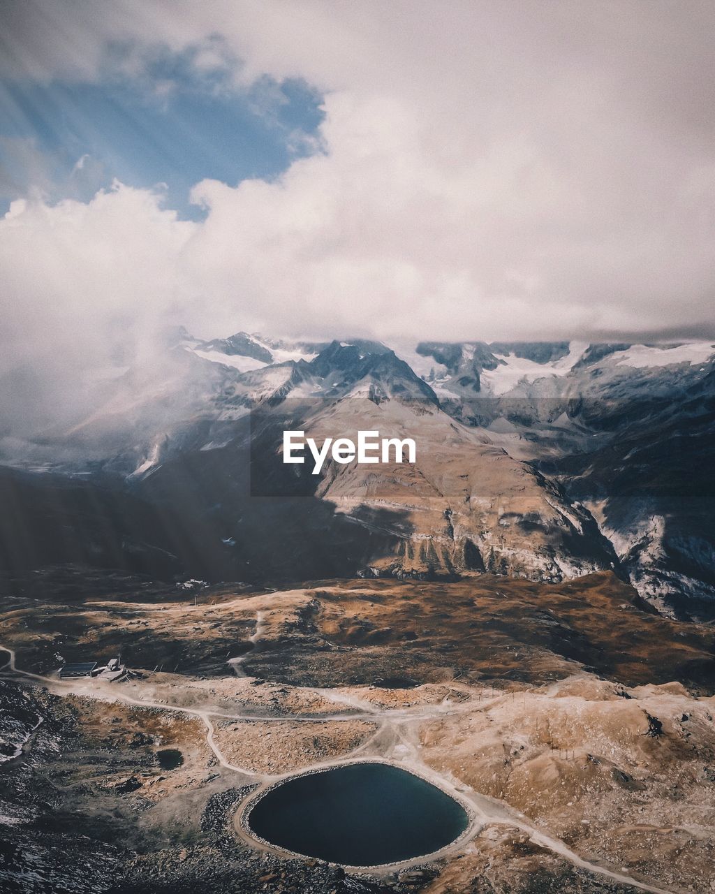 Scenic view of mountains against cloudy sky