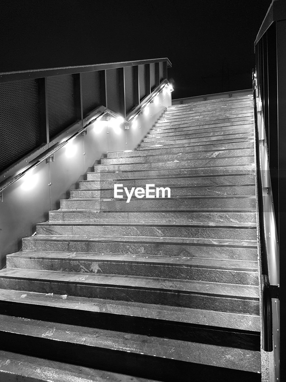 LOW ANGLE VIEW OF ILLUMINATED STAIRCASE AT RAILROAD STATION