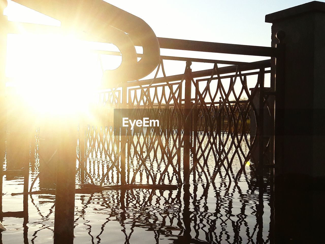 SUN SHINING THROUGH RAILING