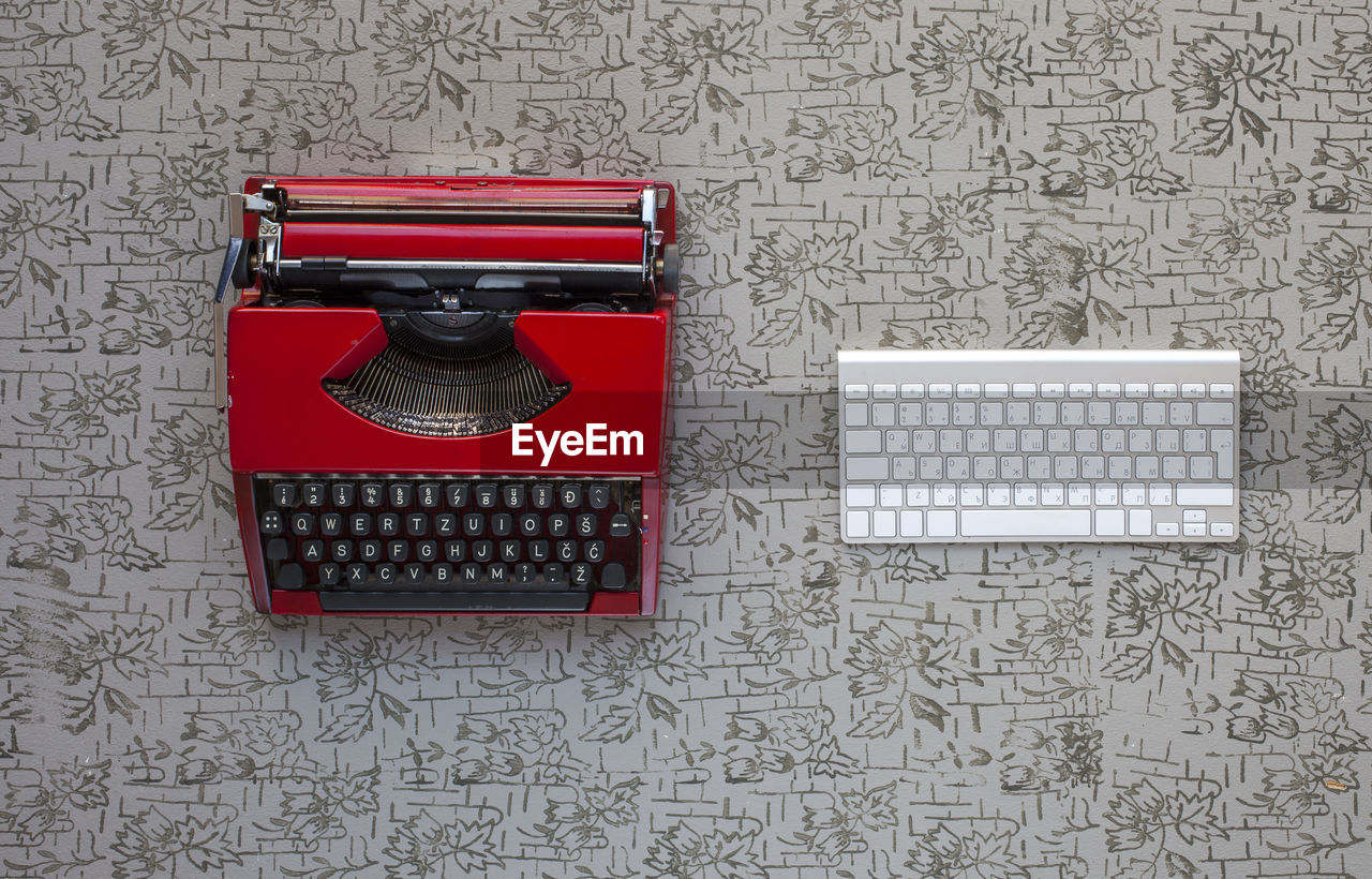 High angle view of vintage typewriter and keyboard on table