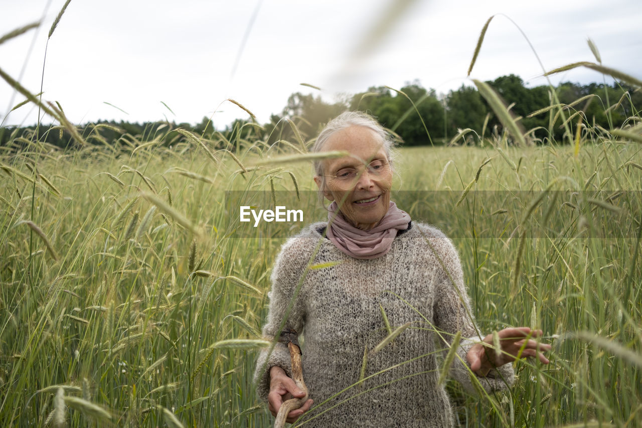 Senior woman walking in field