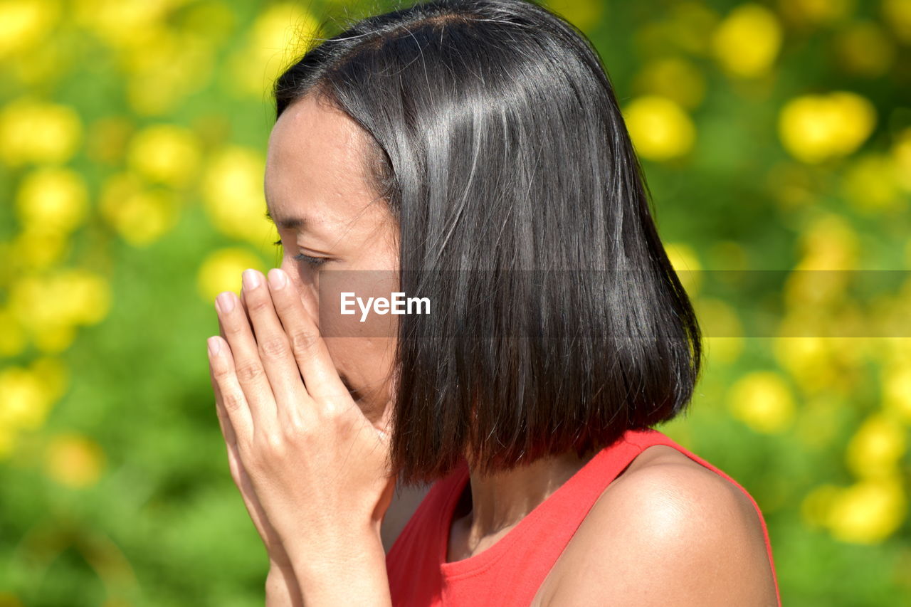 Close-up woman covering mouth