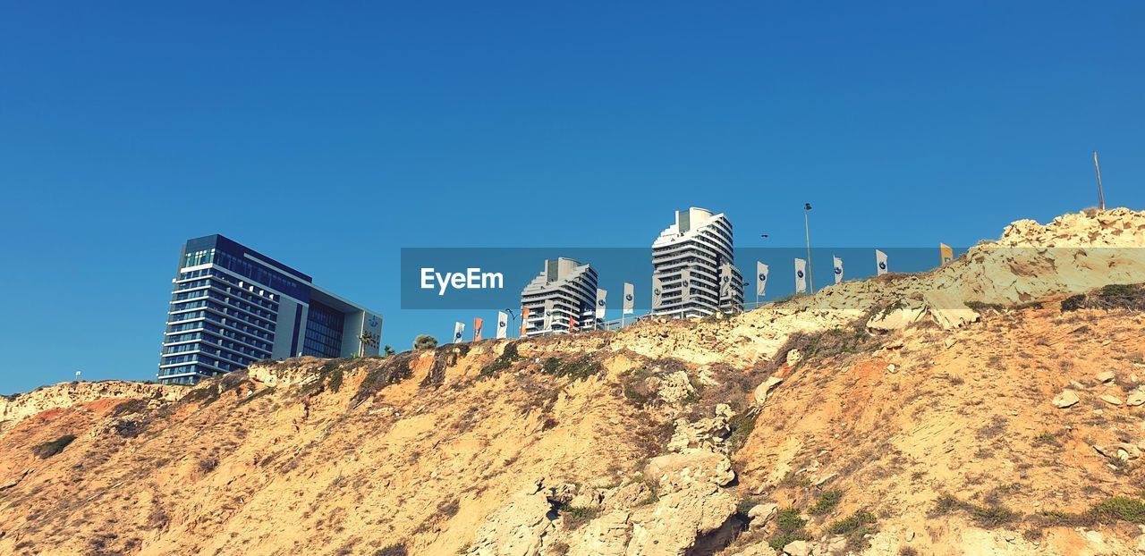 LOW ANGLE VIEW OF BUILDINGS AGAINST CLEAR SKY