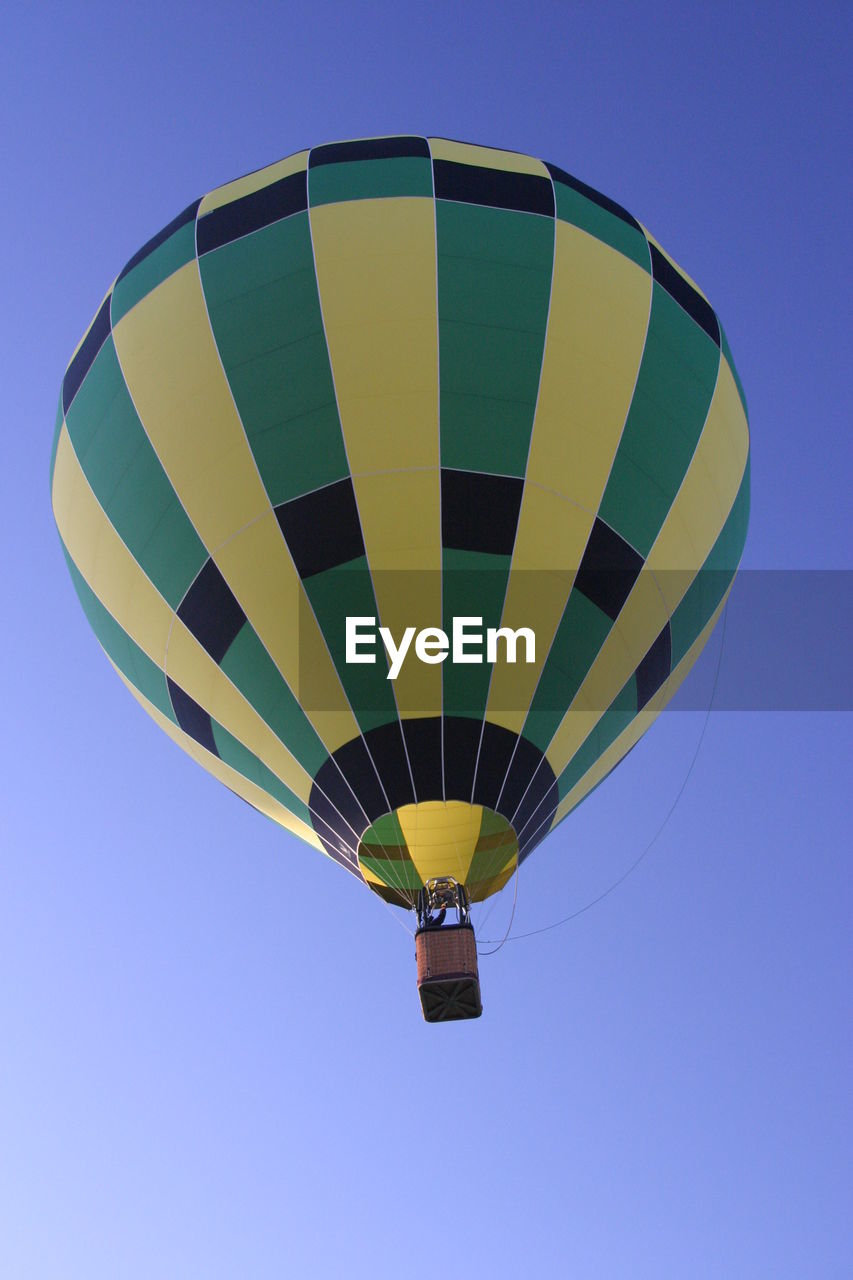 Low angle view of hot air balloon against blue sky