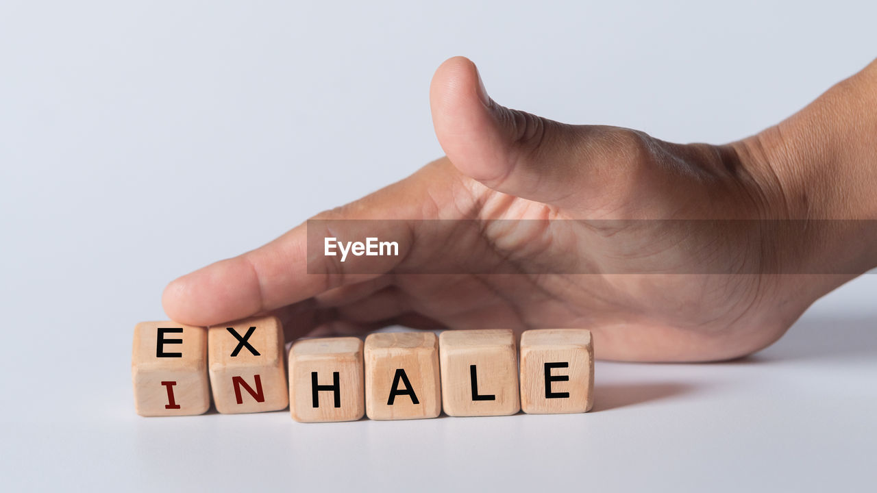 Human hand with text inhale and exhale