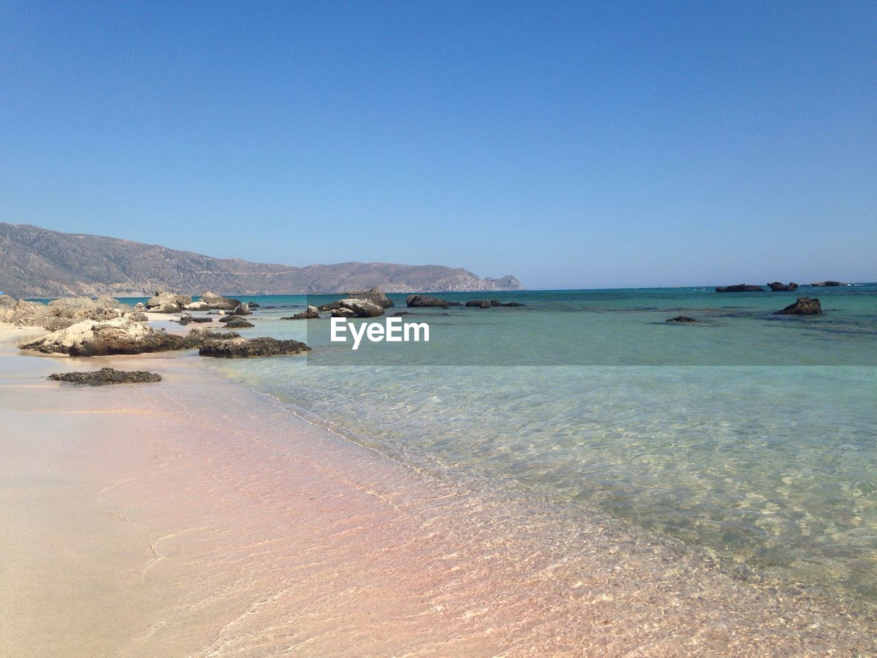 Scenic view of sea against clear blue sky