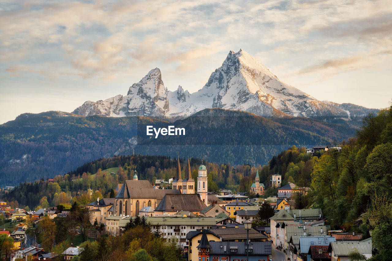 Panoramic view of buildings and mountains against sky