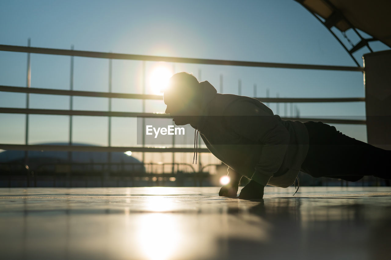 Caucasian male boxer warming up before a fight in the ring outdoors