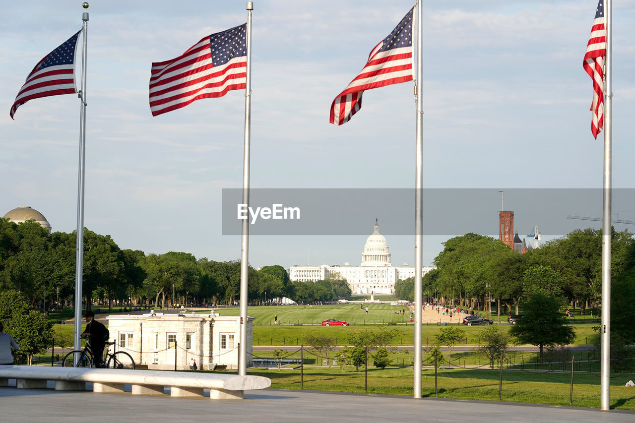 Low angle view, raw of american flags at washington monument, senate capitol and national mall 