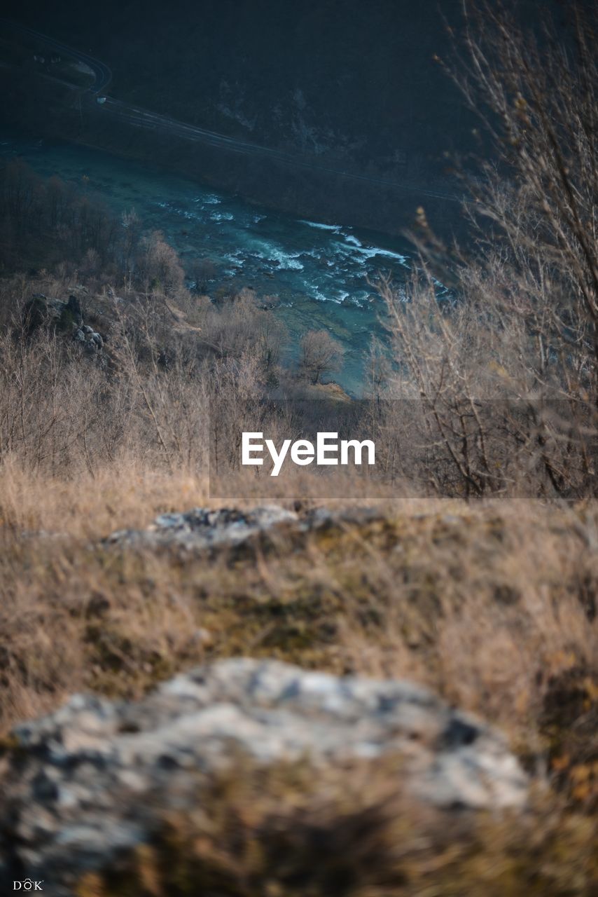 SCENIC VIEW OF WATERFALL AGAINST SKY