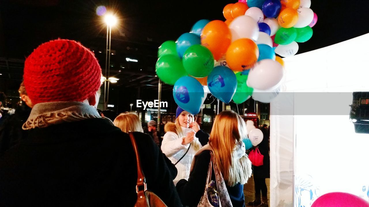 HIGH ANGLE VIEW OF PEOPLE WITH BALLOONS AT MARKET