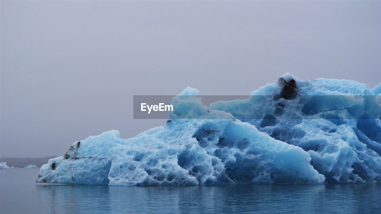 Frozen sea against clear sky