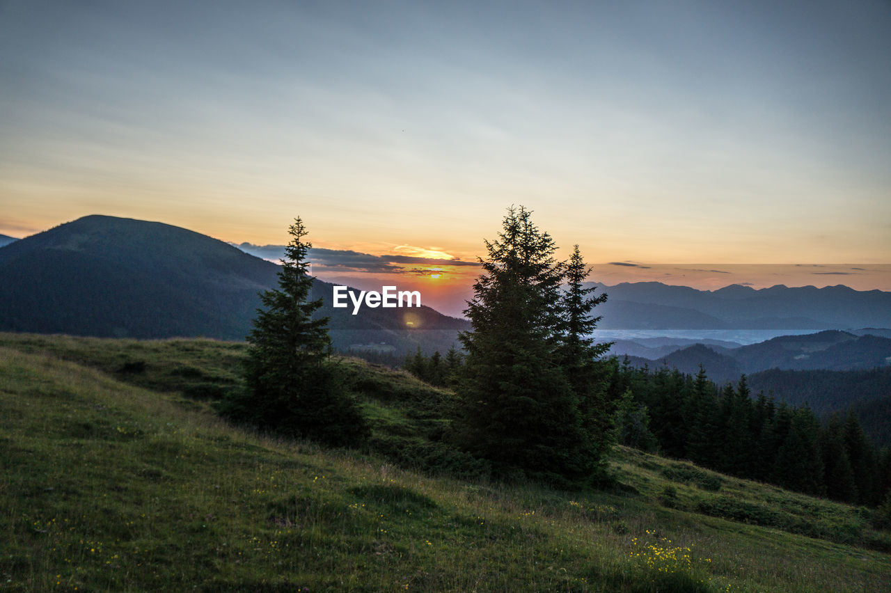 SCENIC VIEW OF MOUNTAIN AGAINST SKY DURING SUNSET