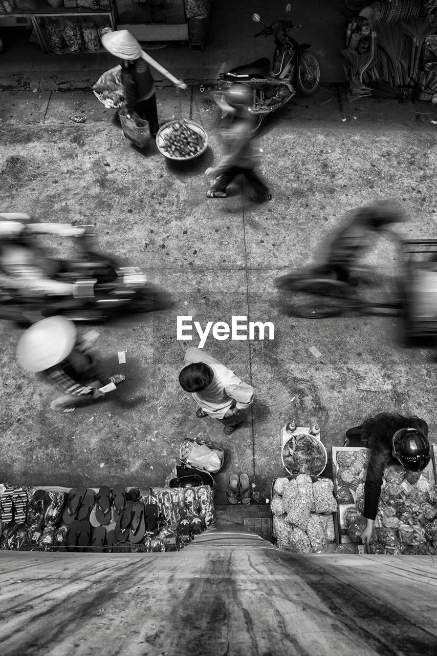 High angle view of man standing on street market in city