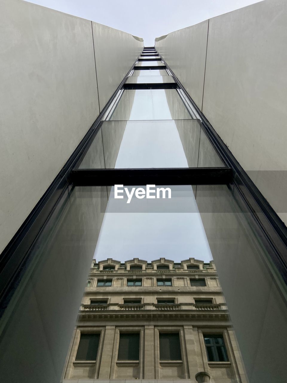 Low angle view of modern building with reflection 