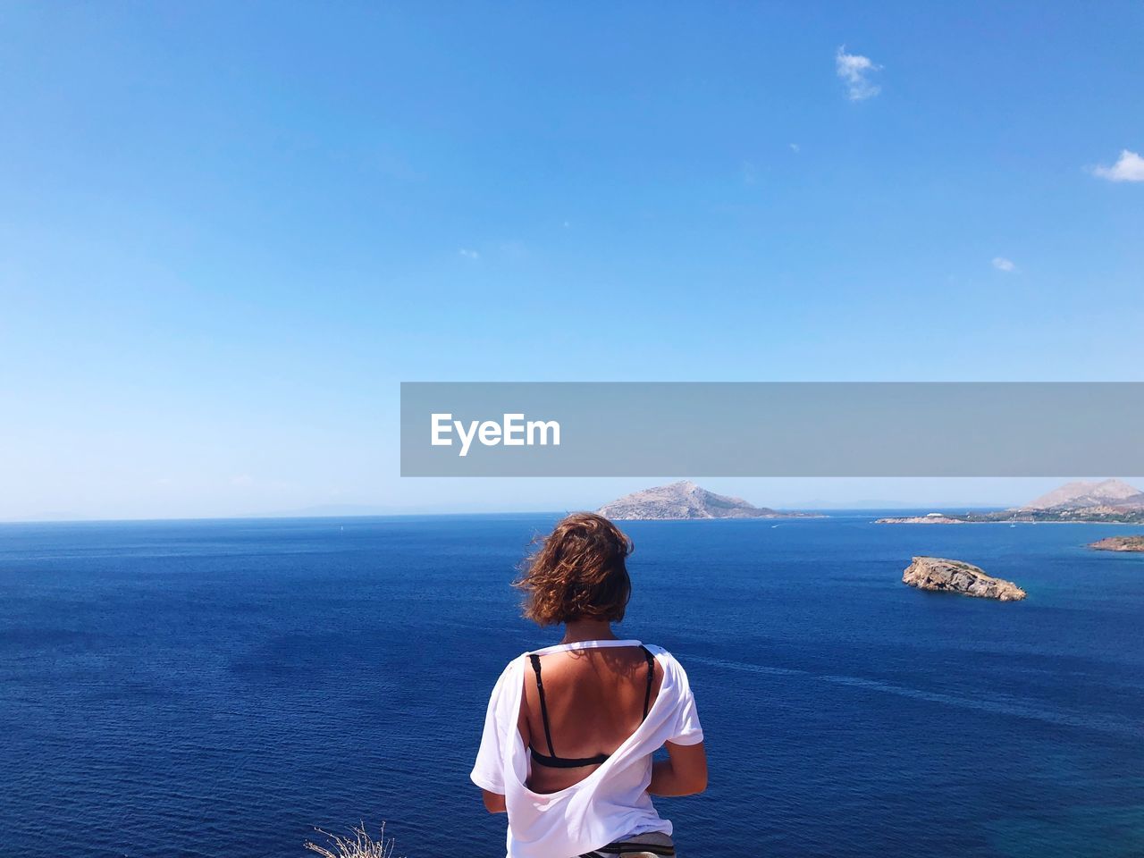 Rear view of woman looking at sea against sky