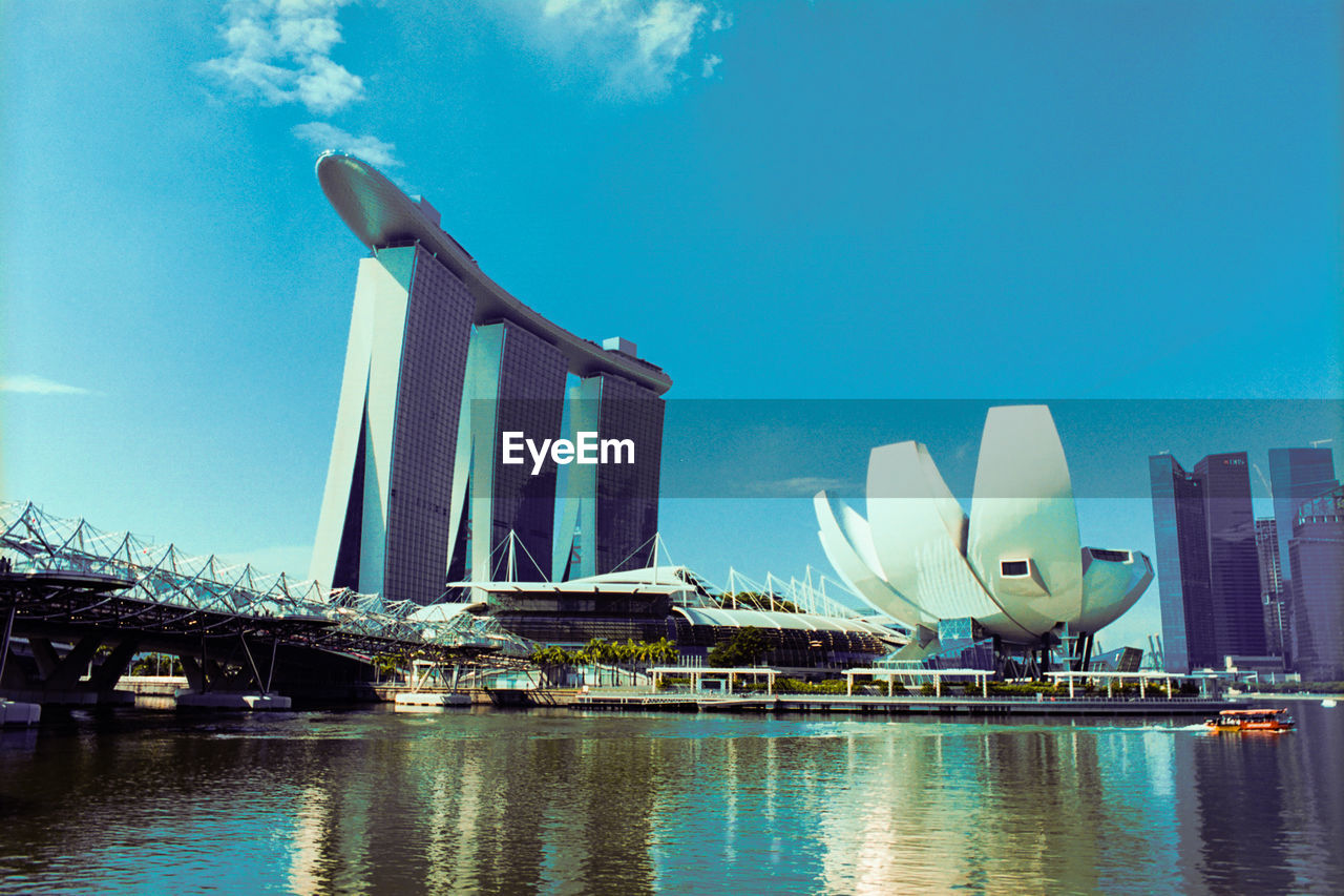 VIEW OF SKYSCRAPERS AT WATERFRONT