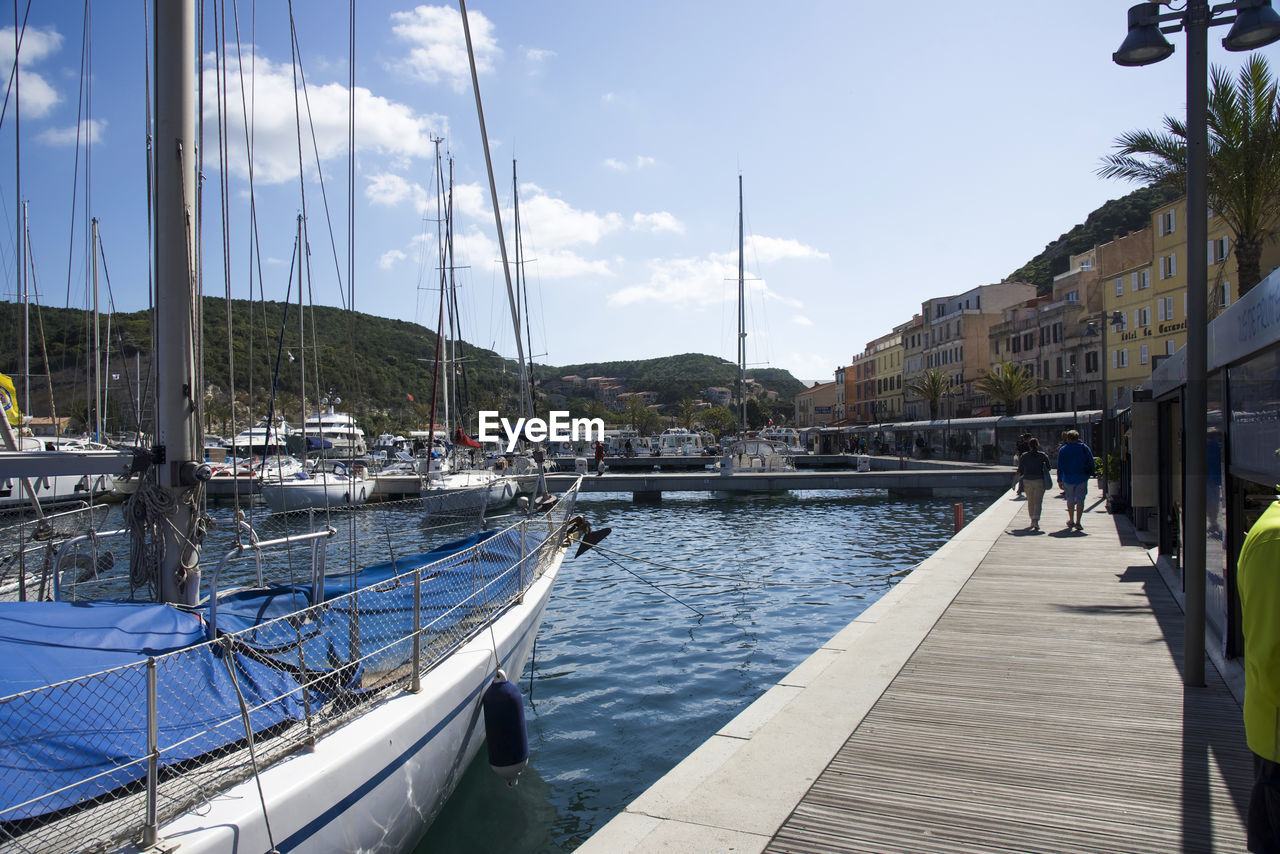 PANORAMIC VIEW OF CITY BY RIVER AGAINST SKY