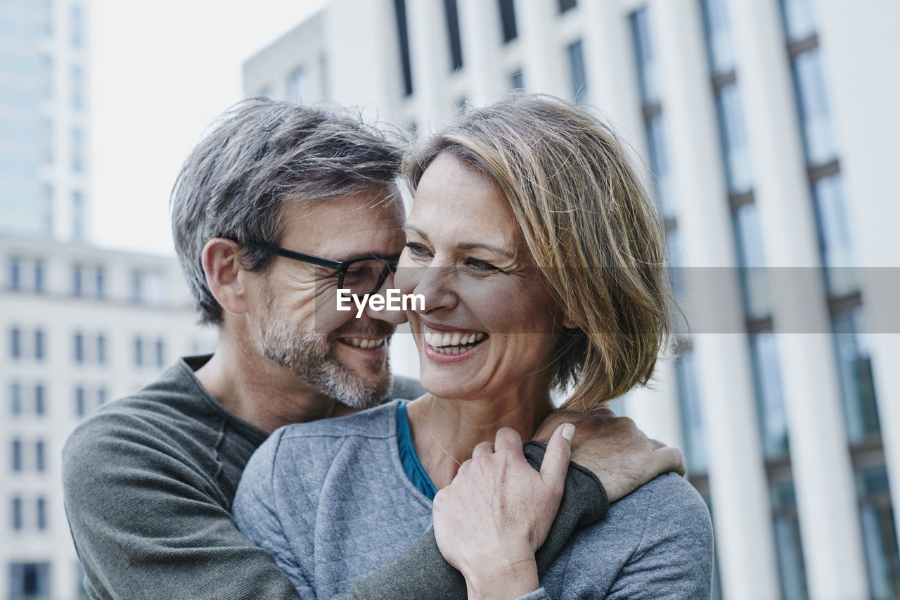 Happy mature couple hugging outdoors